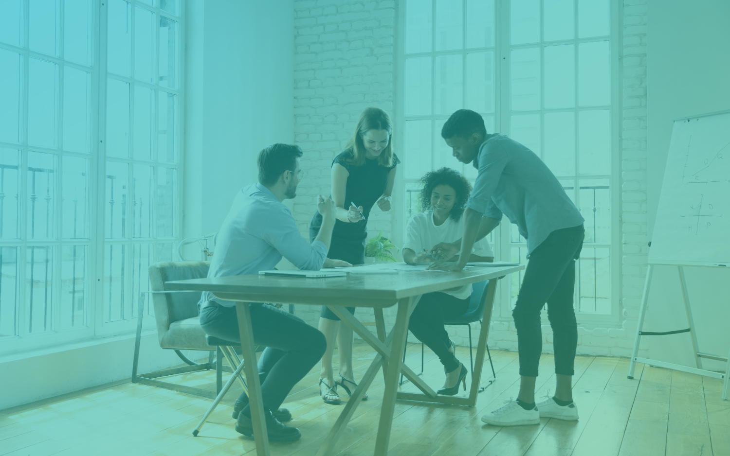 Four BCW  marketing professionals working at a table