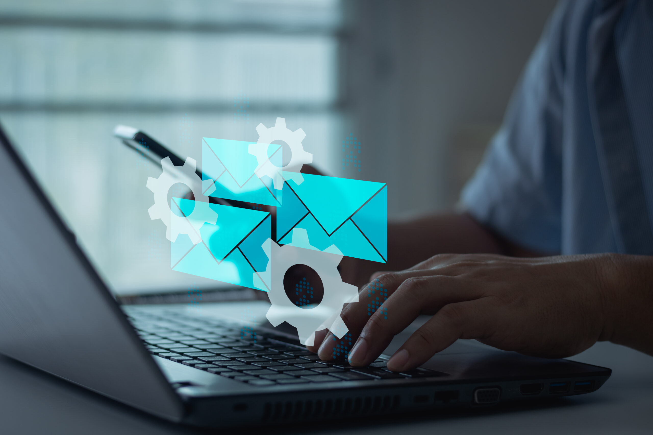 The image features a person using a laptop with BCW  illustrations of gears and envelopes floating above their hands, symbolizing the use of AI tools to optimize email campaigns. The gears represent automation or mechanics of the system, while the envelopes suggest communication or email marketing. The overall theme suggests enhancing email marketing strategies through automation and AI technology.